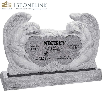 Kneeling angels embracing double heart granite headstone